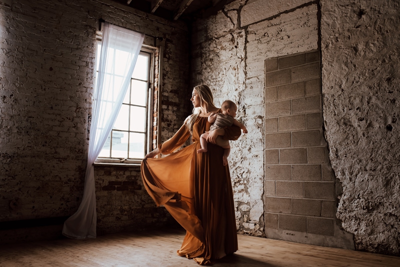 Maternity Photography, Mother twirling with young children next to window