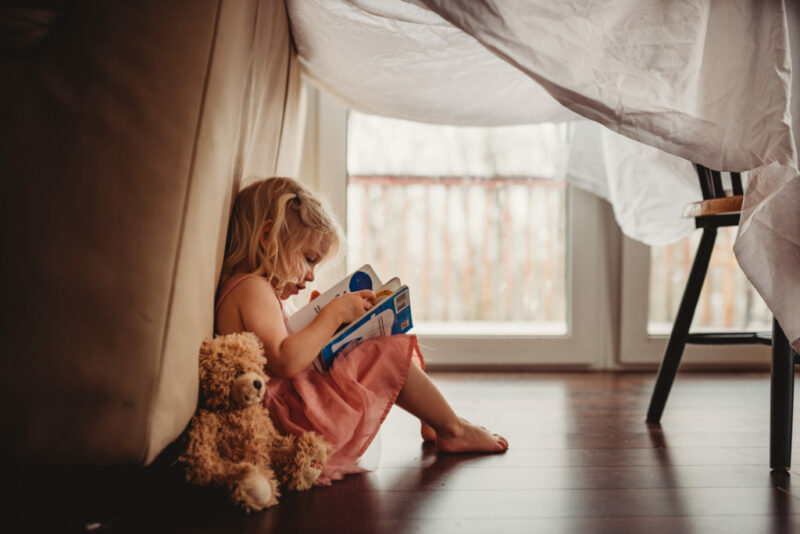 Photograph of a kid reading a book