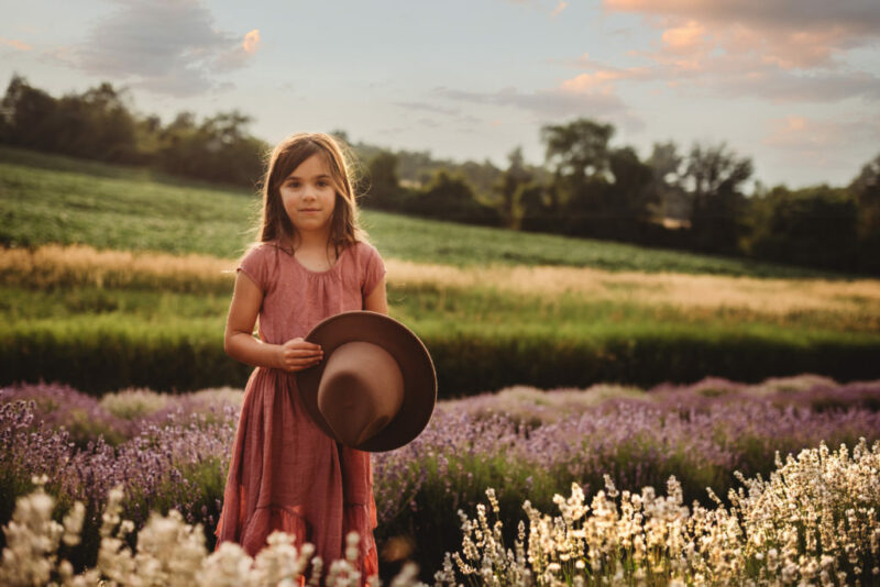 Young girl looking at the cameral during a lavender family photography session