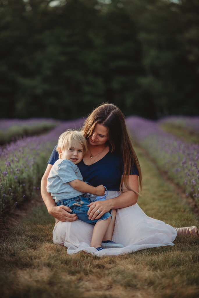 Mother holding her youngest son in the lavender fields   in port hope, ontario
