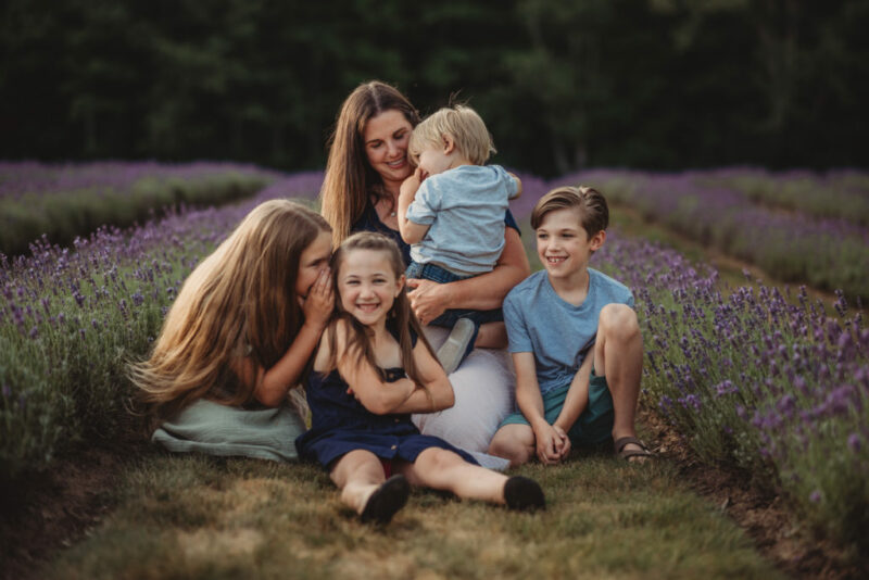 Mother and her four children sitting in between lavender rows