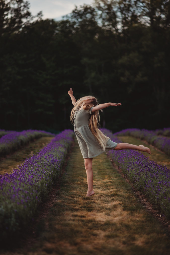 Young girl dancing in the lavender fields 

