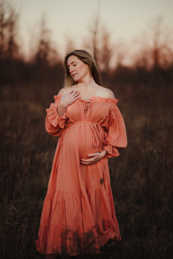 Pregnant woman holding her belly during a Bowmanville maternity photography session