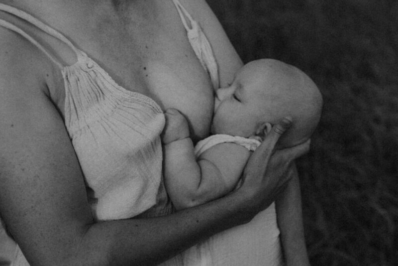 Black and white image of a baby nursing