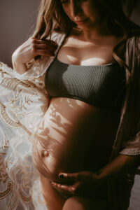 Maternity Photography, Woman holding her belly during maternity photoshoot in Bowmanville